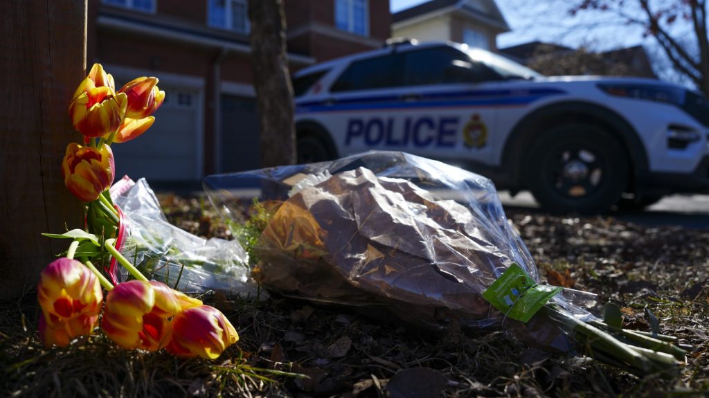 Flowers on the property where members of a Barrhaven family were murdered.