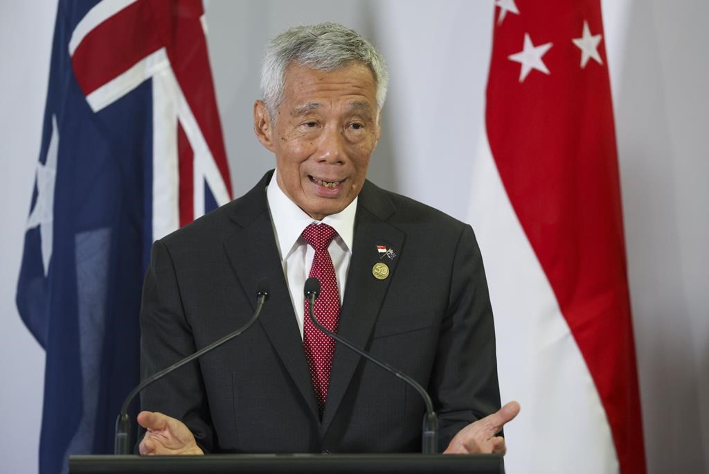 Singapore's outgoing prime minister will stay on as senior minister, his successor says