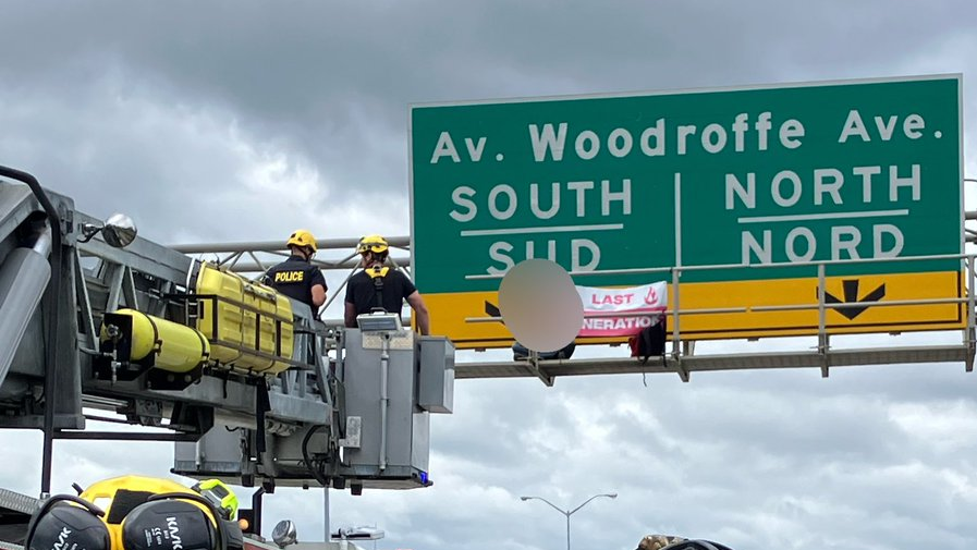 Climate advocates rescued by Ottawa fire, arrested for climbing Hwy. 417 signs