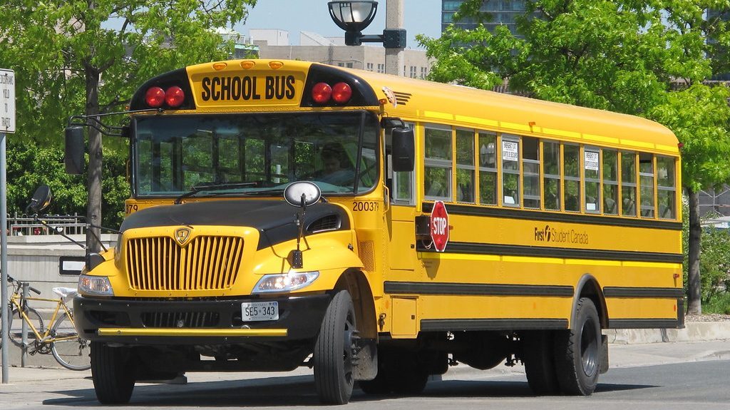 14 elementary school students on bus when it collided with a minivan