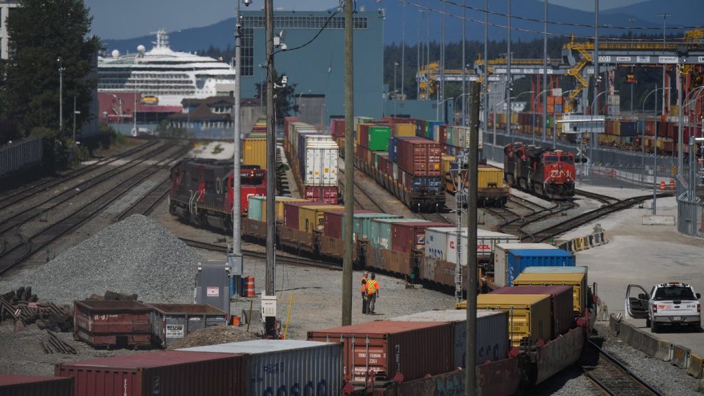 A CN Rail train moves cargo containers at the Centerm Container Terminal at port in Vancouver, on