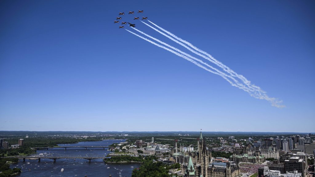 Royal Canadian Air Force Snowbirds and a CF-18 fly over Parliament Hill during a flypast celebrating the RCAF centennial, on Canada