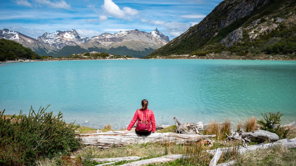 Tourist enjoying the beautiful views of Laguna Esmeralda in Ushuaia, Argentina.