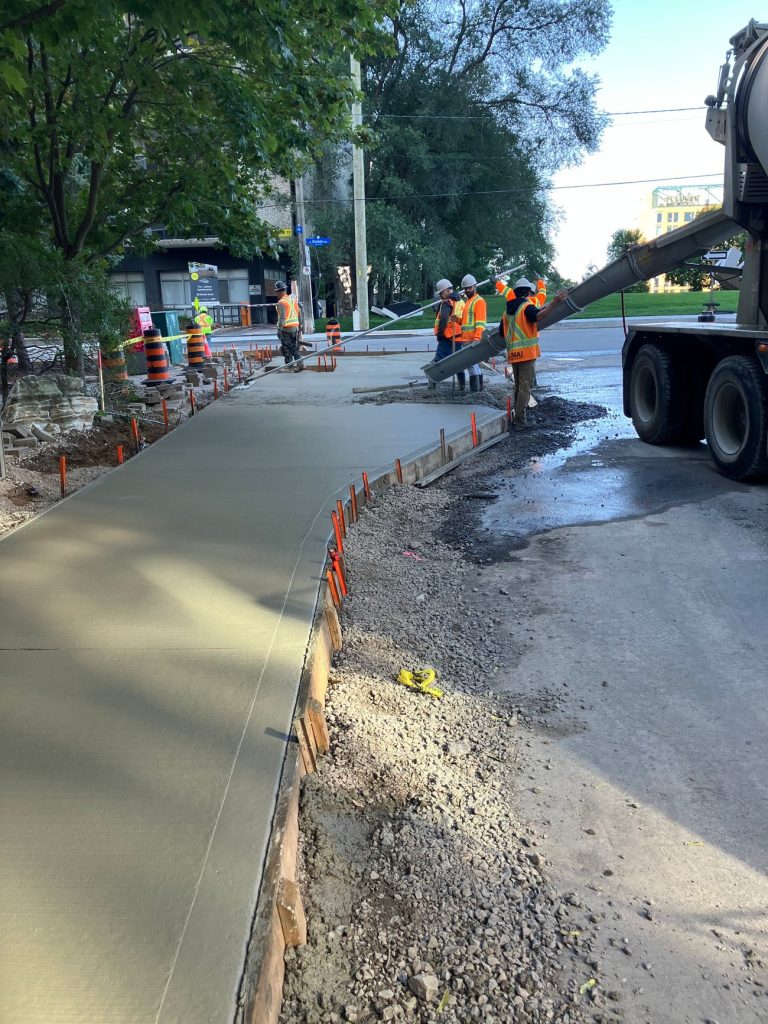 New sidewalk construction on the south side of Queen Street between Bay Street and Bronson Avenue, looking west (August 2024). Photo by City of Ottawa.