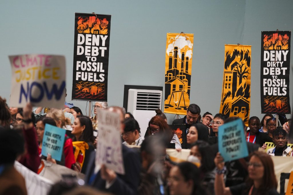 Protesters gather at UN climate talks in global day of action as progress on a deal slows