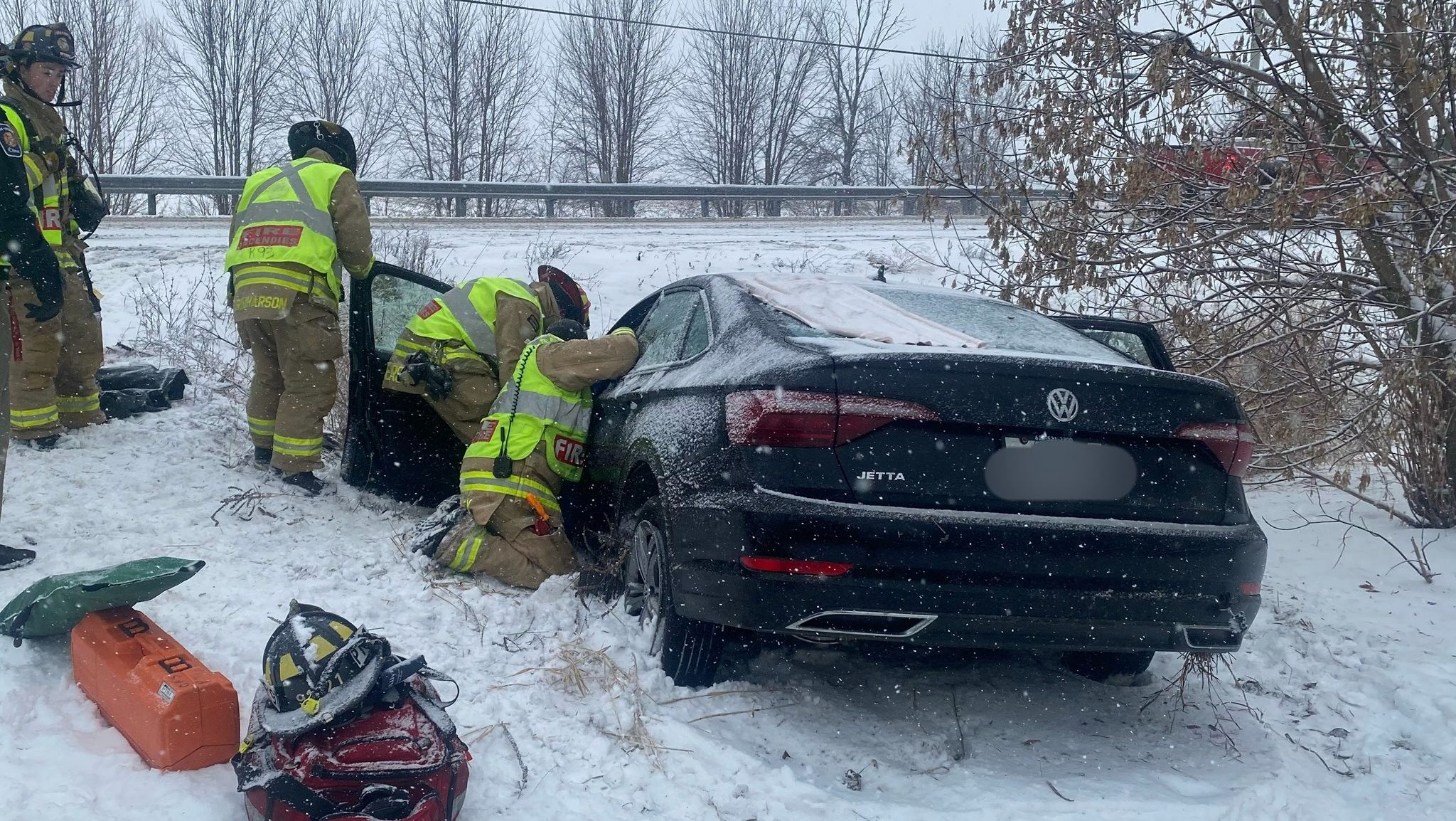 Ditch-bound car traps driver on snowy travel day