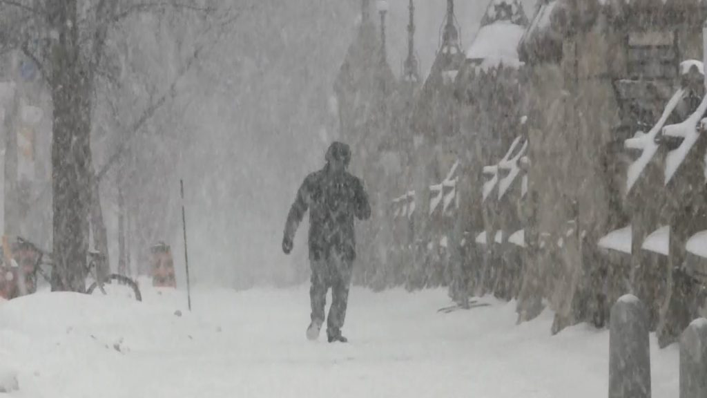 Person walking on sidewalk in snow